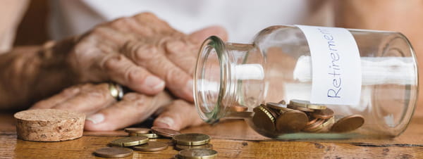 old woman looking at change on her table