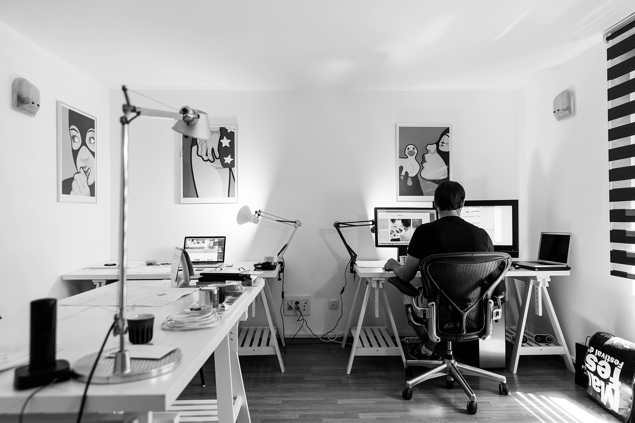 black and white image of a computer desk