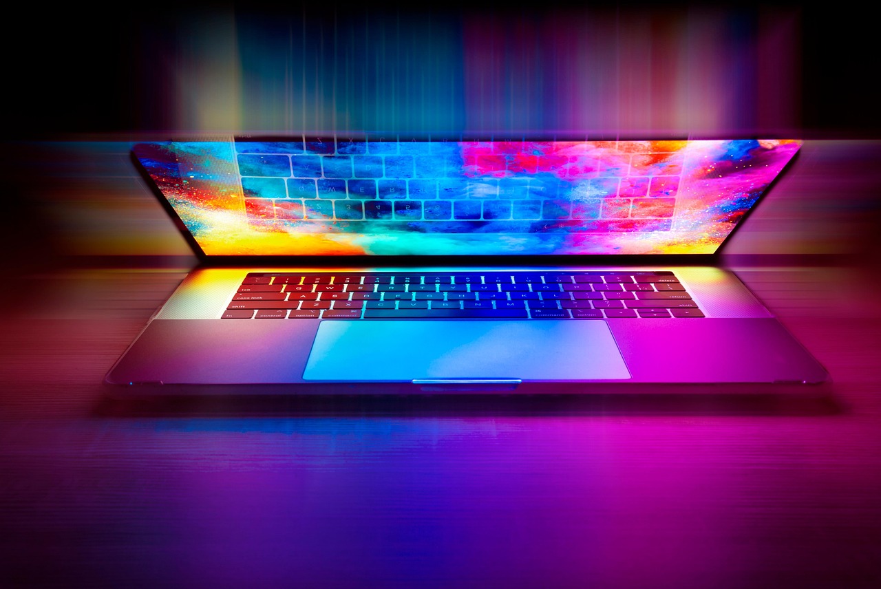 A picture of a laptop computer with a lot of bright colors coming from it