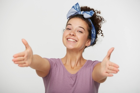 smiling woman wide open arms for a hug